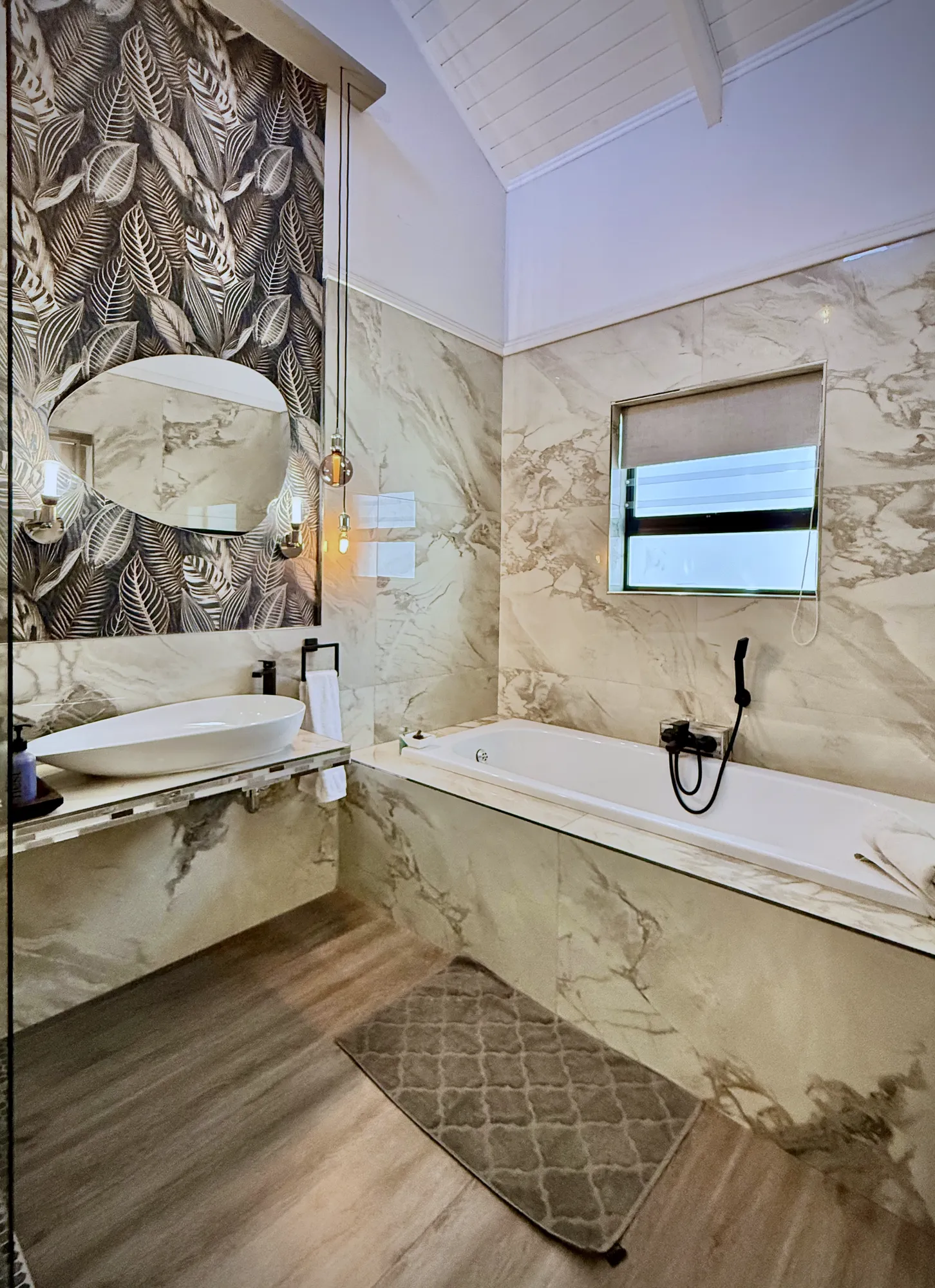 Birch Luxury Studio marble bathroom with a deep bath