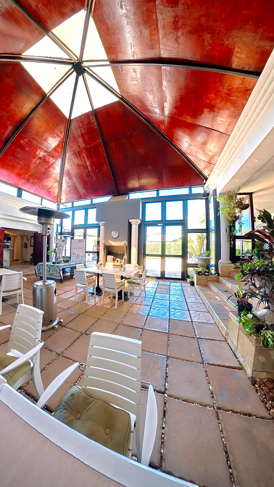 The courtyard conservatory under its red glass dome
