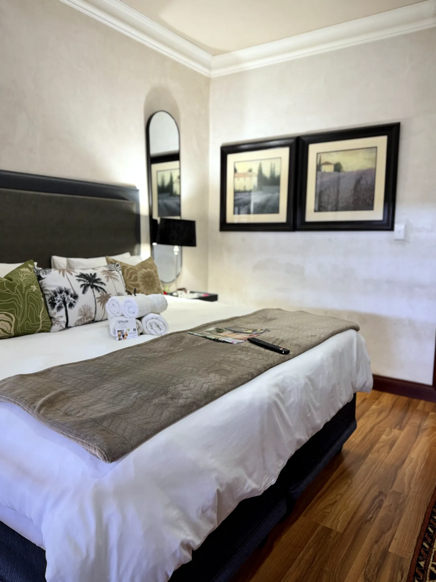 Luxury East Suite: king super-size bed with framed art and wooden floors