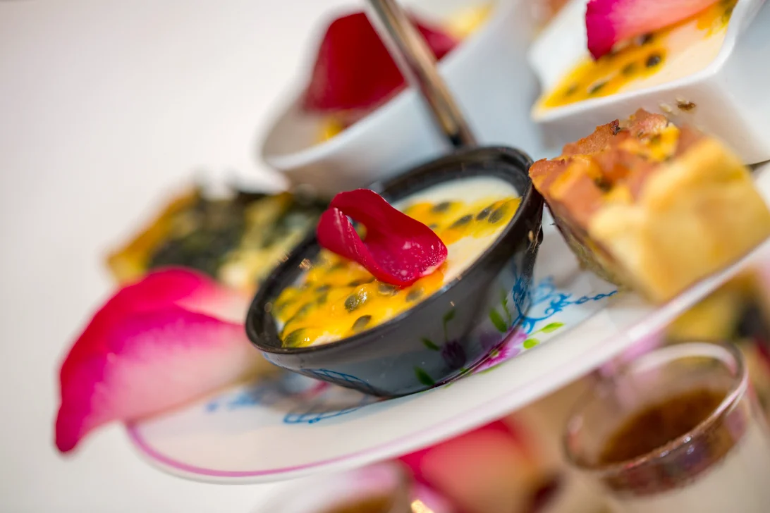 Passion fruit cream topped with a rose petal at a Spacube high tea