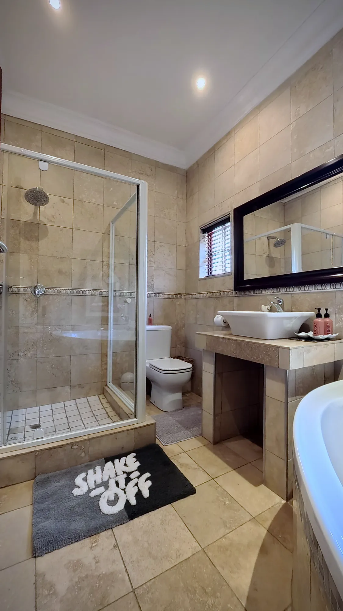 Luxury South Suite bathroom with glass shower and basin