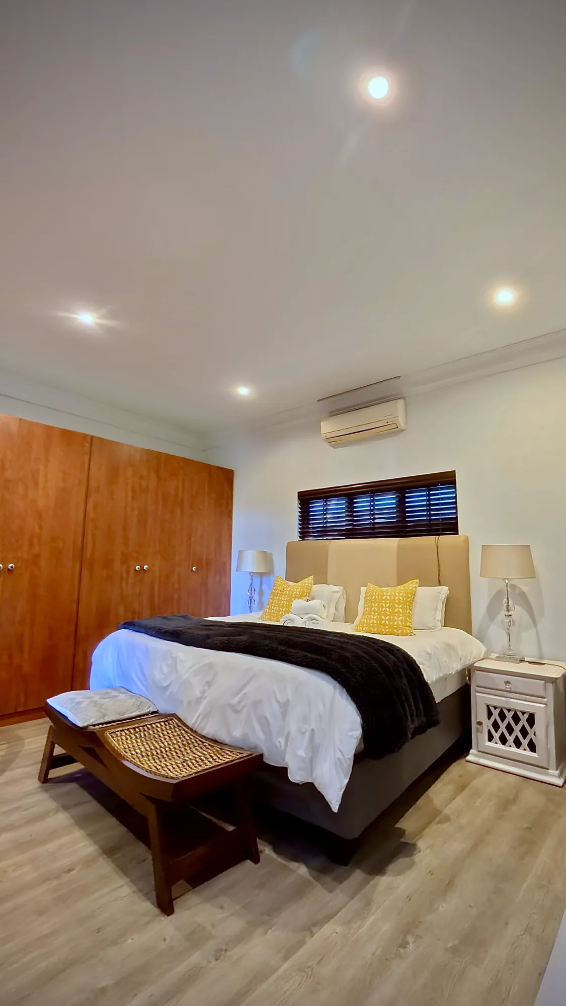 Luxury West Suite: king super-size bed, wooden bench and built-in cupboards