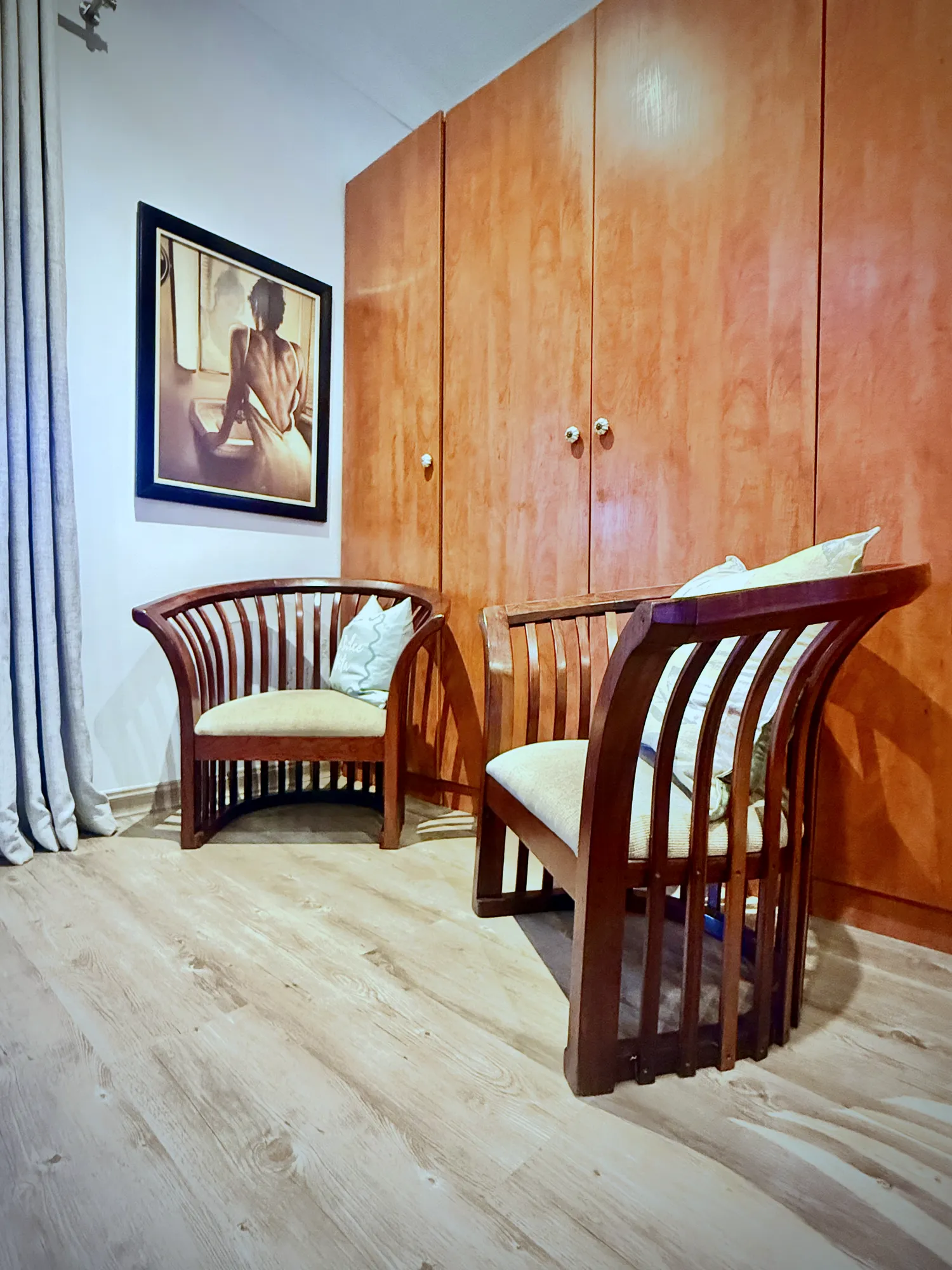 Luxury West Suite seating with two wooden armchairs